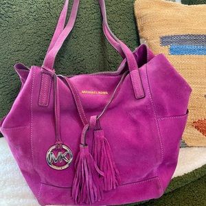 Michael Kors plum/pomegranate suede slouch bag with tassels.